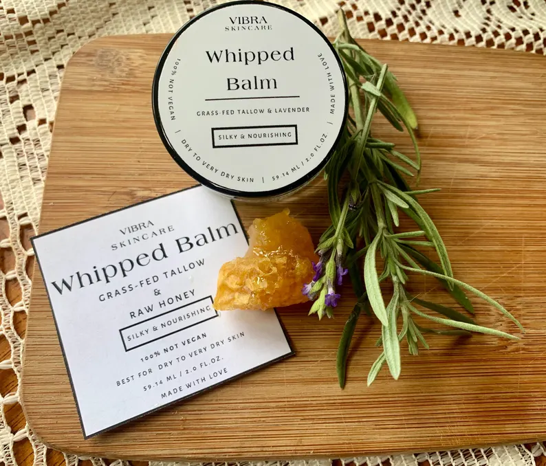 Grass Fed Tallow Whipped Lavender & Honey Body Lotion Balm image on a background showing ingredients in natural form.